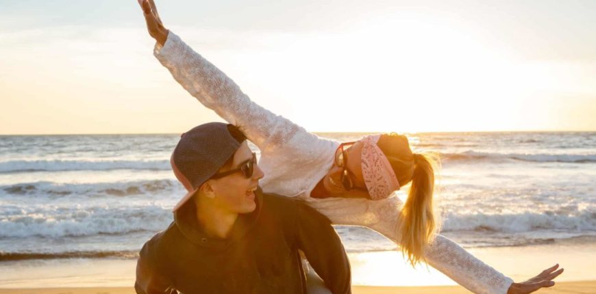 Couple-flying-high-on-a-beach-at-dusk-16_9-1200x675.jpg