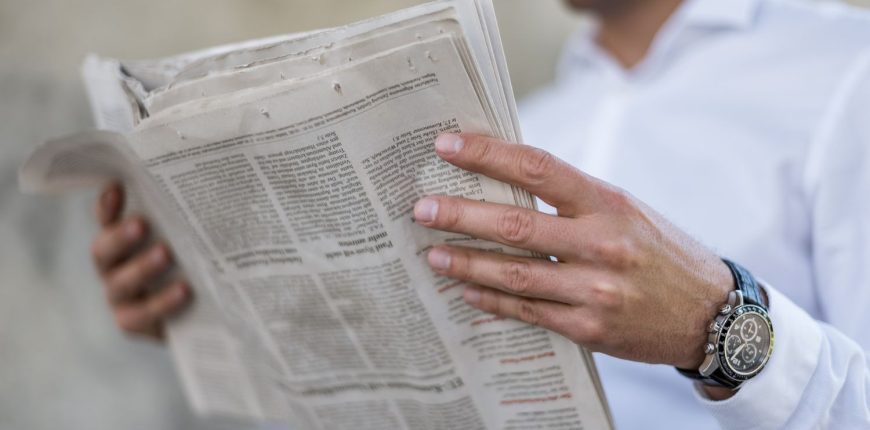 close-up-of-businessman-reading-newspaper-1023146588-676dd958d5f040f09c8b889237725113.jpg