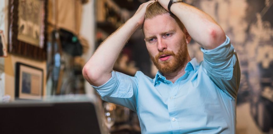 frustrated-man-looking-at-stocks-tanking-on-his-laptop-iStock-898249816.jpg