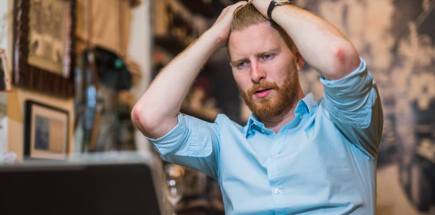 frustrated-man-looking-at-stocks-tanking-on-his-laptop-iStock-898249816.jpg