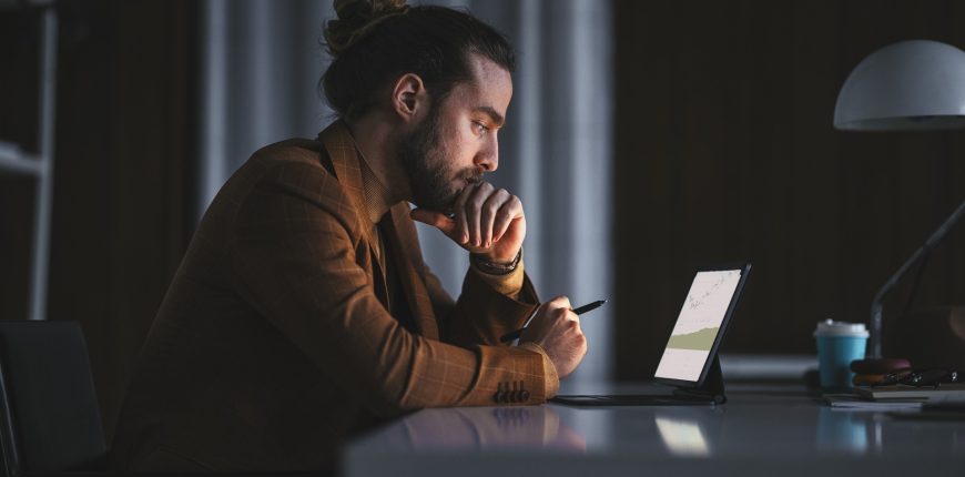 man-studies-stocks-intently-on-digital-tablet_iStock-1316264191.jpg