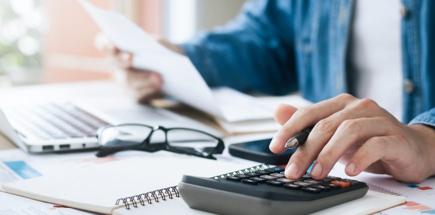man-doing-taxes-calculator-iStock-1437026399.jpg