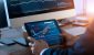 businessman-checking-stock-market-on-digital-tablet-and-a-desktop-computer-with-stock-exchange-graph.jpeg