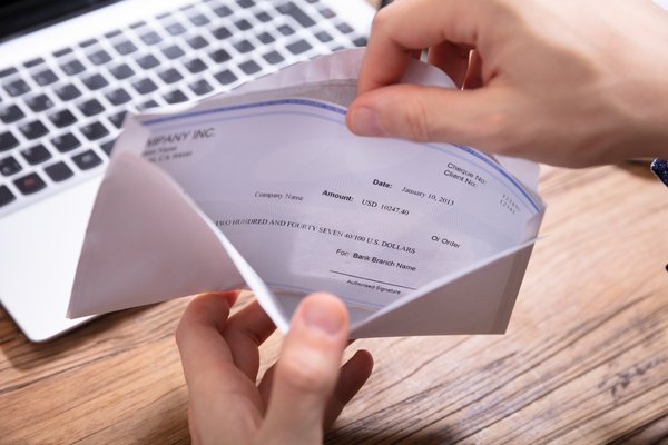 hand_opening_a_check_in_an_envelope.width-600.jpg