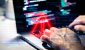 male-hands-using-laptop-with-alert-symbol.jpg