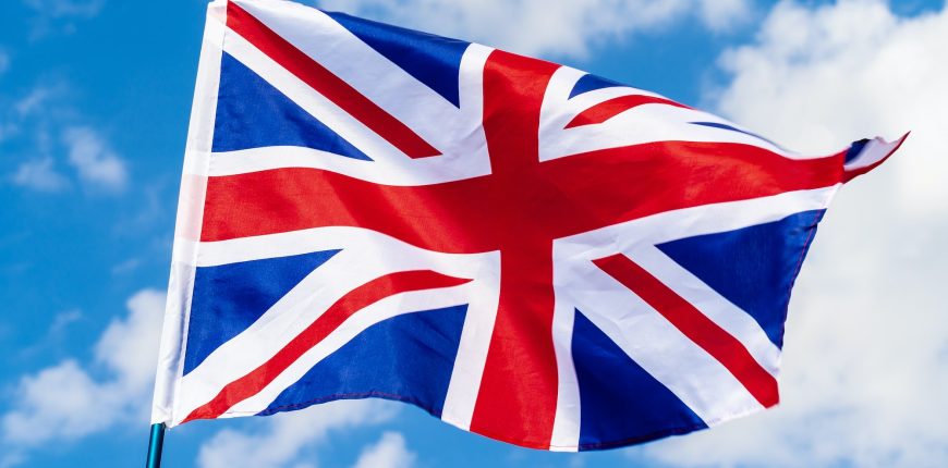 united-kingdom-flag-waving-on-wind-in-blue-sky.jpg