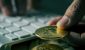 bitcoins-and-man-using-computer-iStock-1200x630.jpg