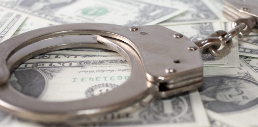 closeup-view-metal-handcuffs-dollars-1024x683.jpg