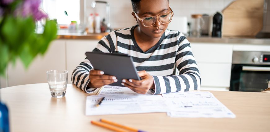 investors-considers-papers-on-a-table-while-holding-a-tablet.jpg