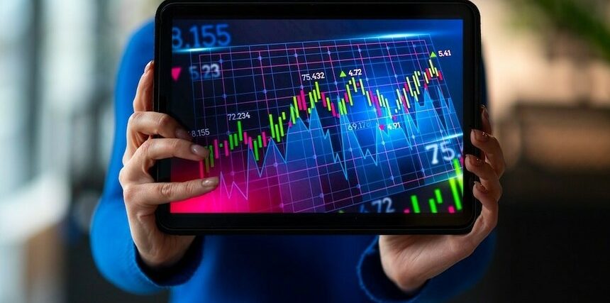 A-person-in-an-office-analyzing-and-reviewing-financial-graphs-for-market-insights.jpg