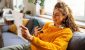 investing-bills-retirement-online-smartphone-automated-woman-couch_iStock-2007594417.jpg