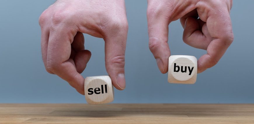 Hands-are-holding-two-cubes-with-the-words-sell-and-buy.jpg