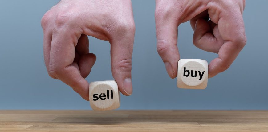 Hands-are-holding-two-cubes-with-the-words-sell-and-buy.jpg