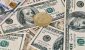 bitcoin-coin-on-scattered-us-hundred-dollar-bills.jpg
