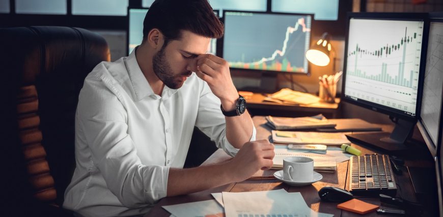 depressed-overworked-frustrated-man-trader-stocks-computer-crypto_iStock-1130771131.jpg