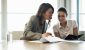 editoral-107670033-two-office-workers-comparing-notebooks-2880x1620.jpg