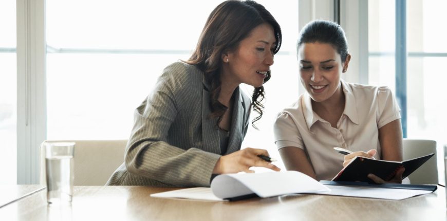 editoral-107670033-two-office-workers-comparing-notebooks-2880x1620.jpg