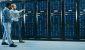 two-software-engineers-walking-down-an-aisle-of-a-data-center.jpg