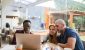three-investors-gather-around-laptop.jpg