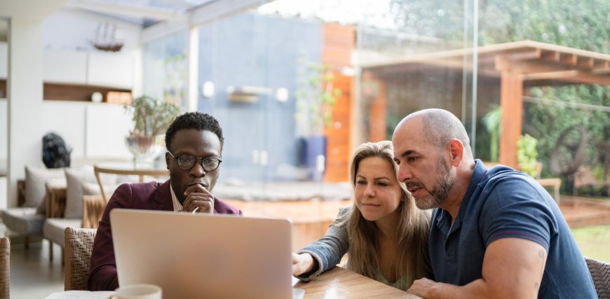 three-investors-gather-around-laptop.jpg