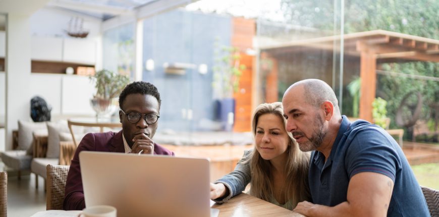 three-investors-gather-around-laptop.jpg