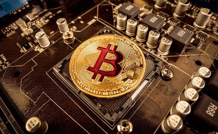 BITCOIN-gold-bit-coin-btc-coins-on-the-motherboard-bitcoi-2021-08-26-22-59-47-utc-696x472.jpg