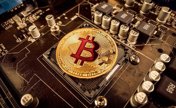 BITCOIN-gold-bit-coin-btc-coins-on-the-motherboard-bitcoi-2021-08-26-22-59-47-utc-696x472.jpg