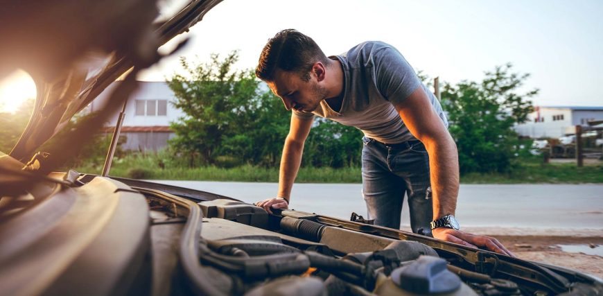 man-looking-under-car-hood.jpg