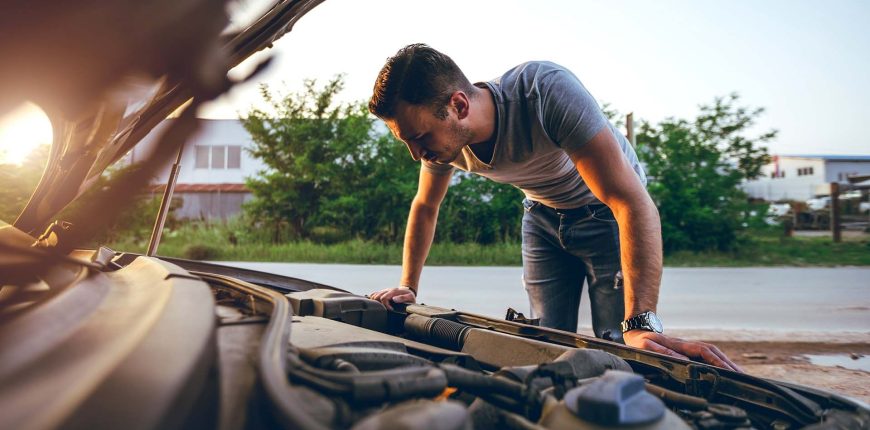 man-looking-under-car-hood.jpg
