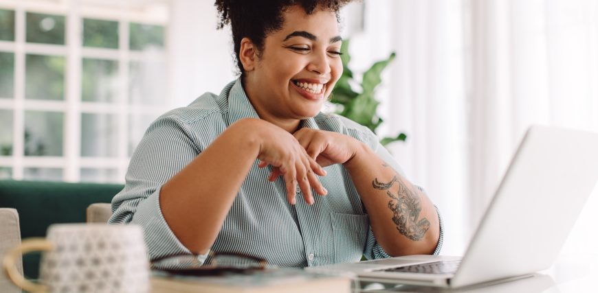 person-using-a-laptop-and-smiling.jpg
