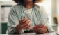 woman-counting-cash-100-dollar-bills_iStock-2190397359.jpg